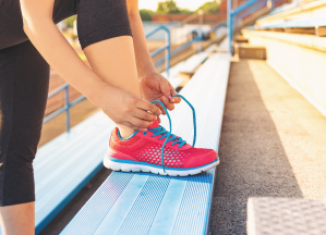 Stay in the Game A woman is tying her pink shoe